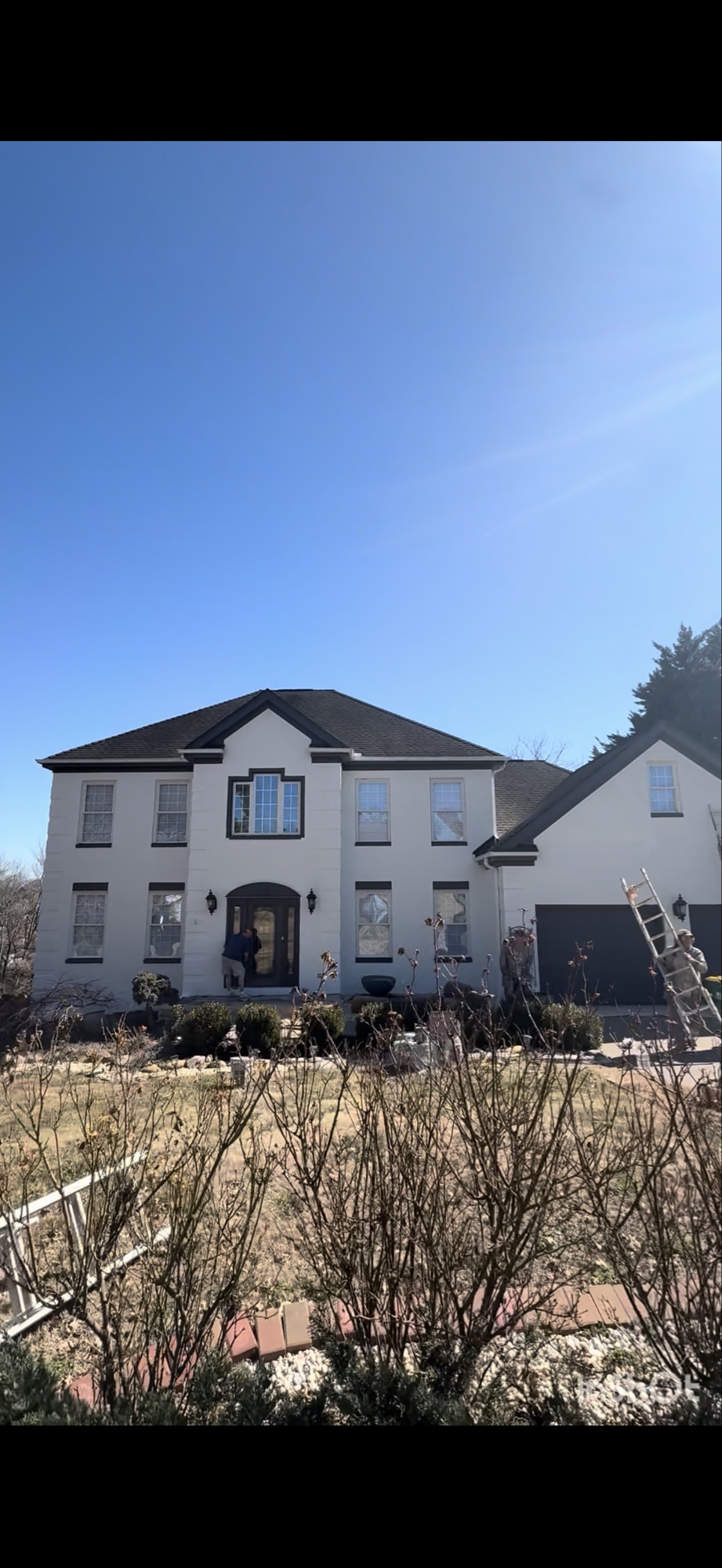 After exterior painting project in Farragut showing the home's updated light painted exterior with dark trim.