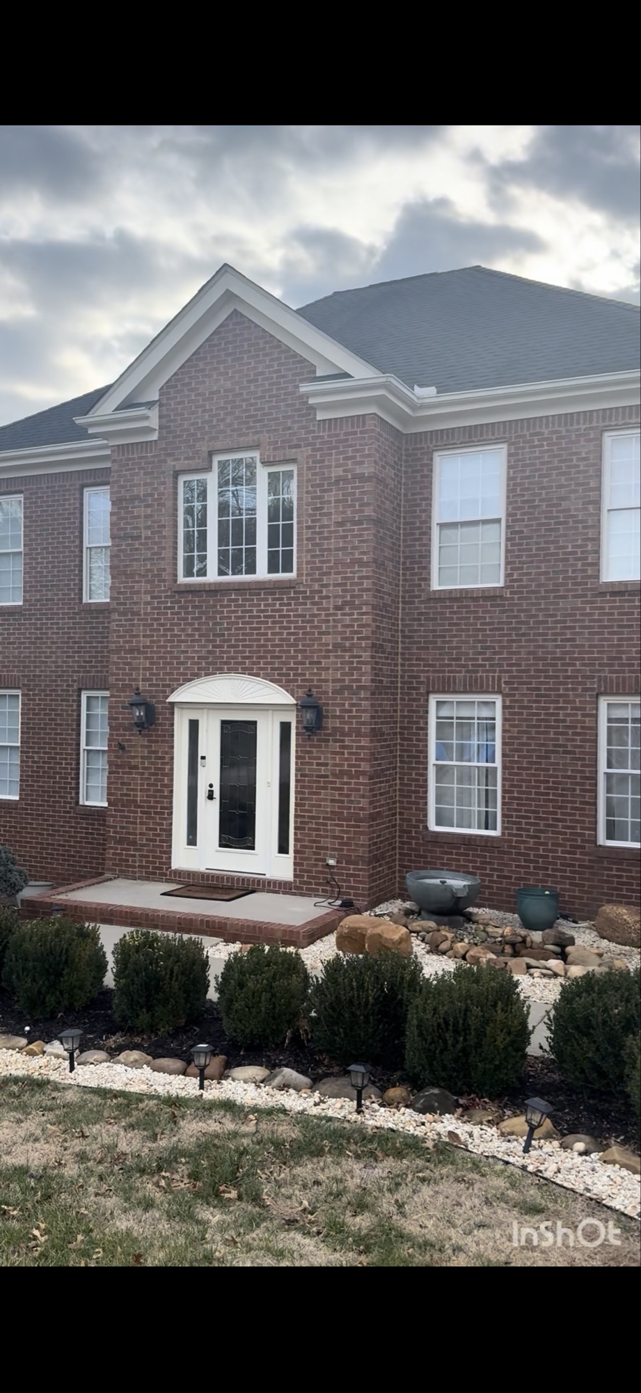 Before exterior painting project in Farragut showing the home's original red brick exterior.