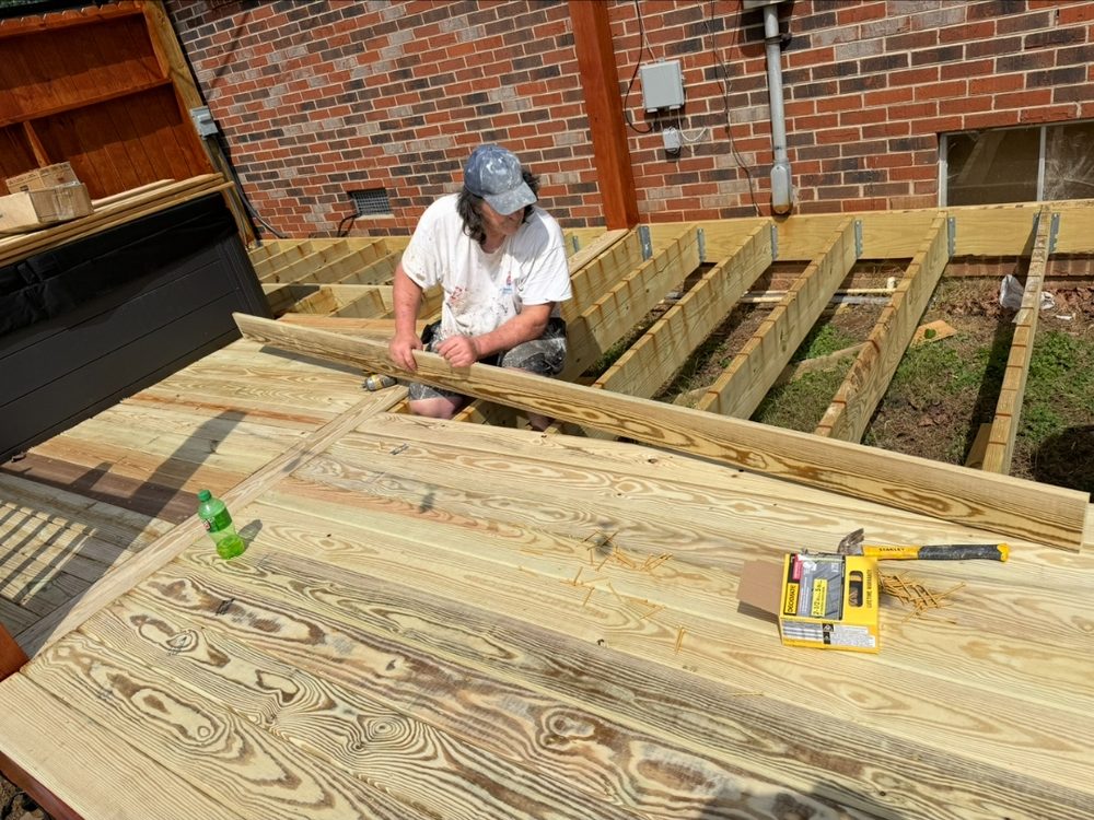 Newly laid pressure treated deck boards on a repaired deck frame