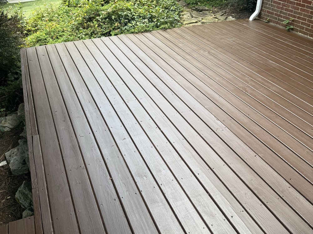 Freshly stained reddish-brown wood deck outside a home in East Tennessee
