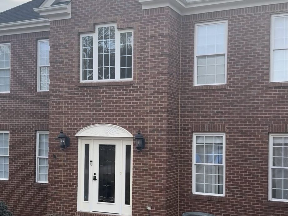 Older two-story brick home photographed before exterior repainting work