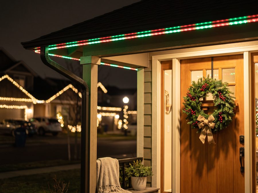 Porch roofline lit in classic red and green for the holidays